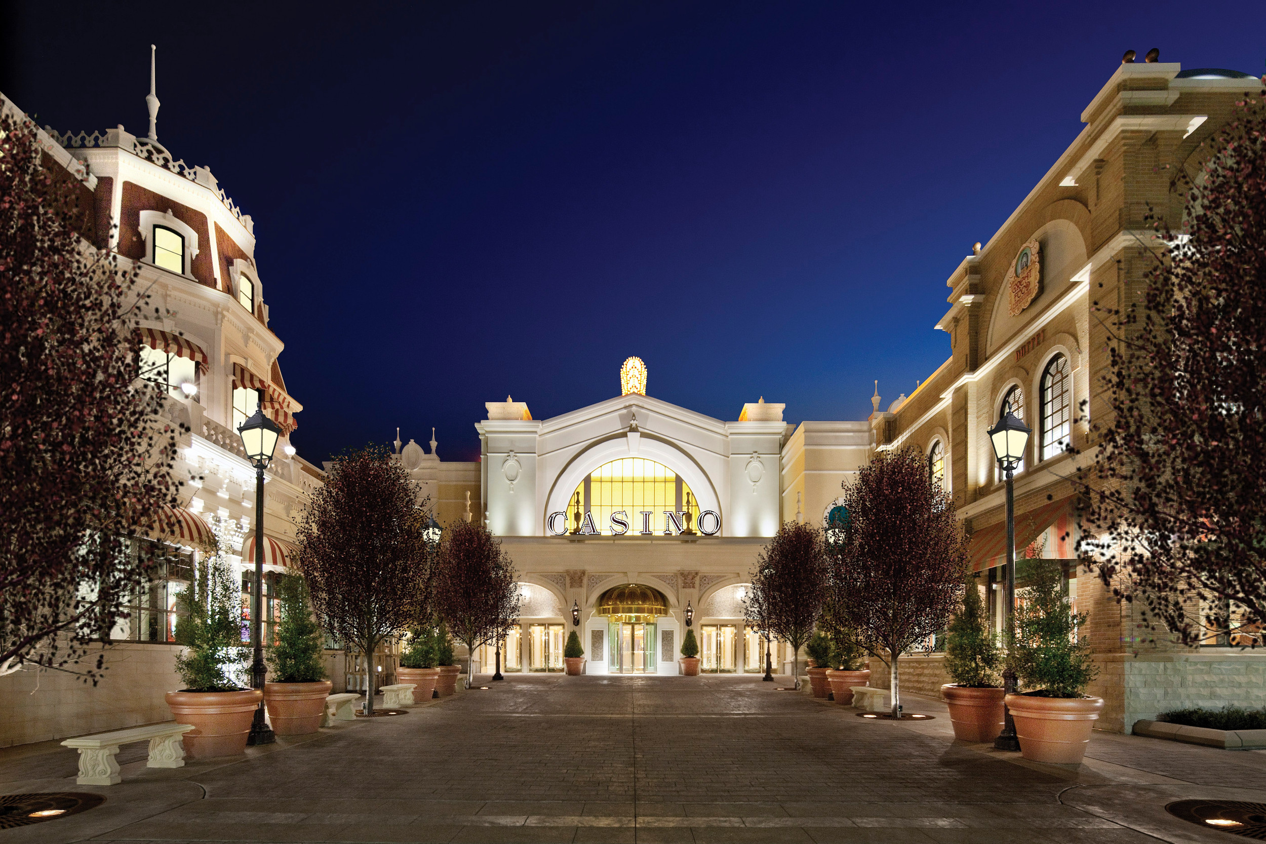 The facade of a brightly lit casino at night.