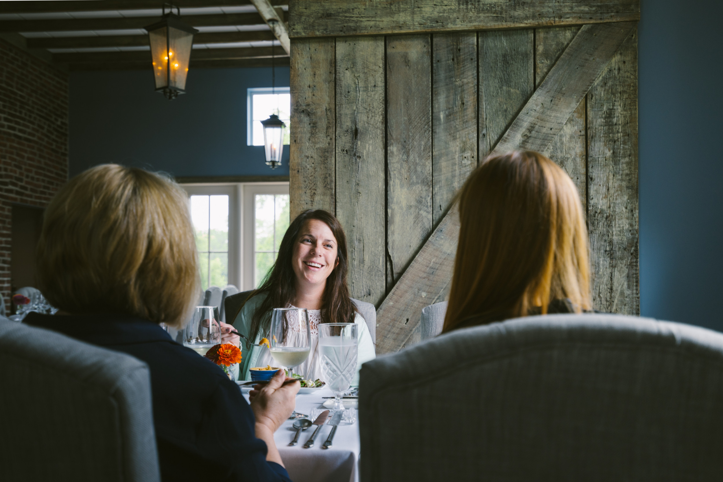 Three women enjoy a meal at Stone Soup Cottage.