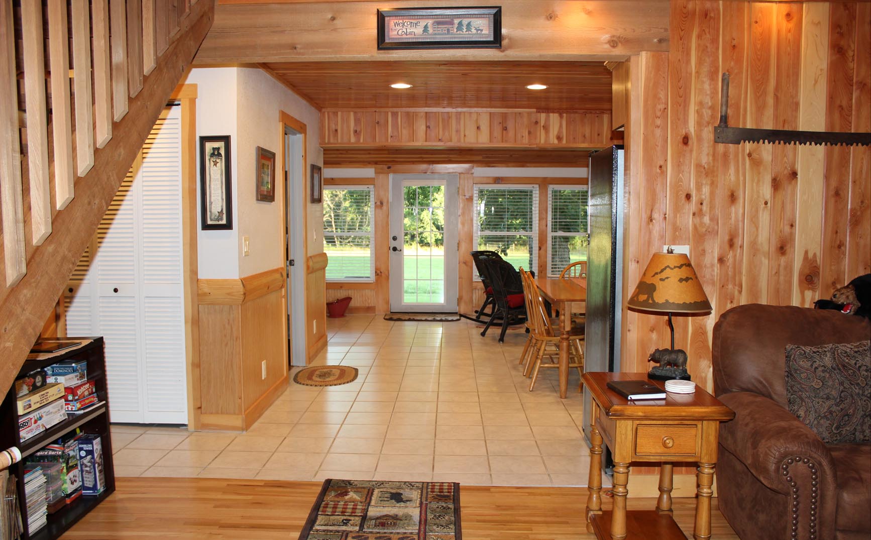 A view inside the cabin from the living room, into the kitchen, to the sitting porch.