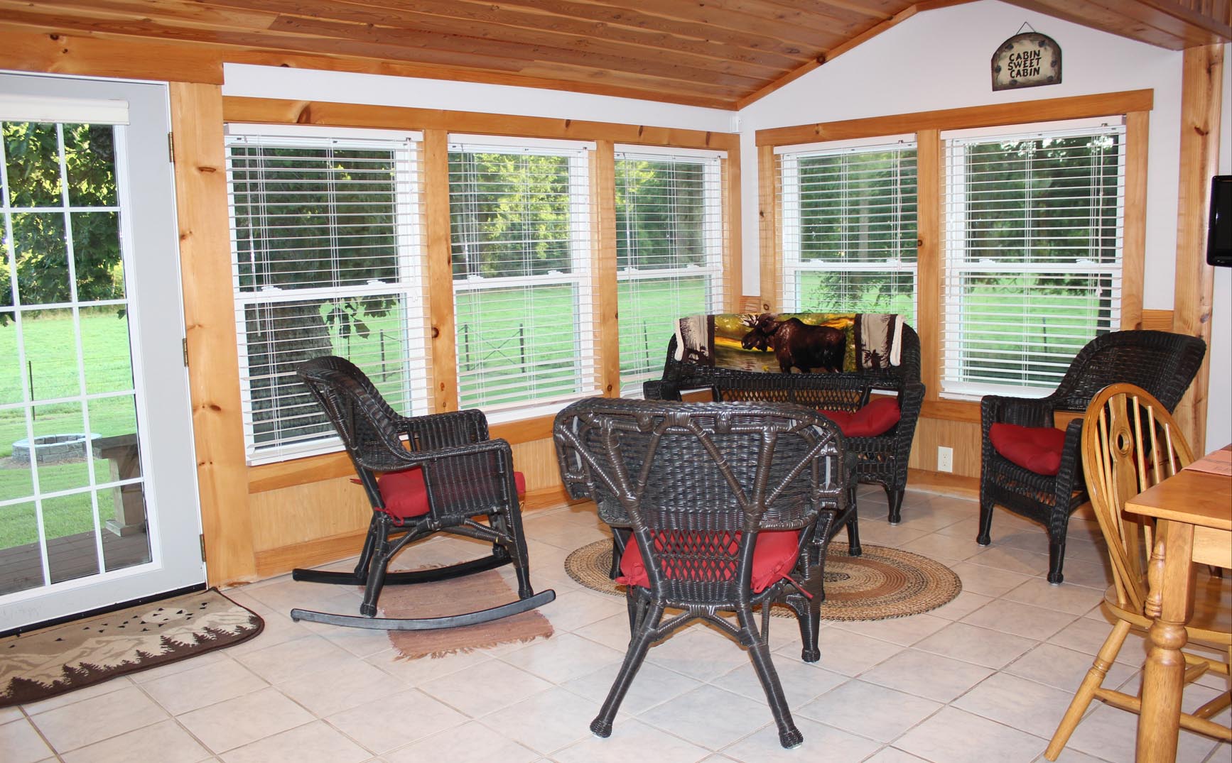 The enclosed porch has a beautiful view of the lower valley and back yard.