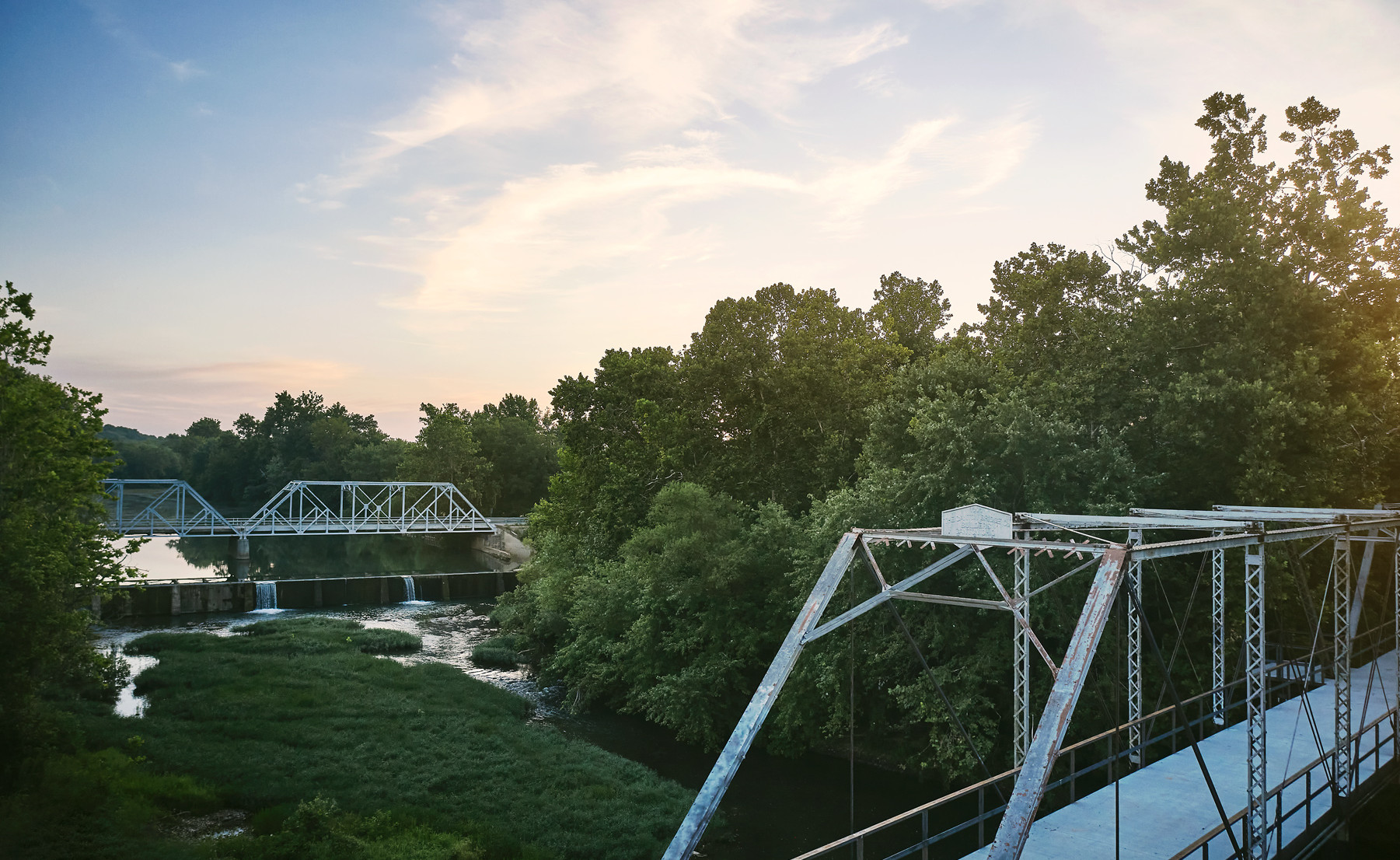The Historic Riverside Bridge spans the Finley River. A paved walking trail allows visitors to experience The Farm, The Ozark Mill, The Riverside Bridge and The Chapel.