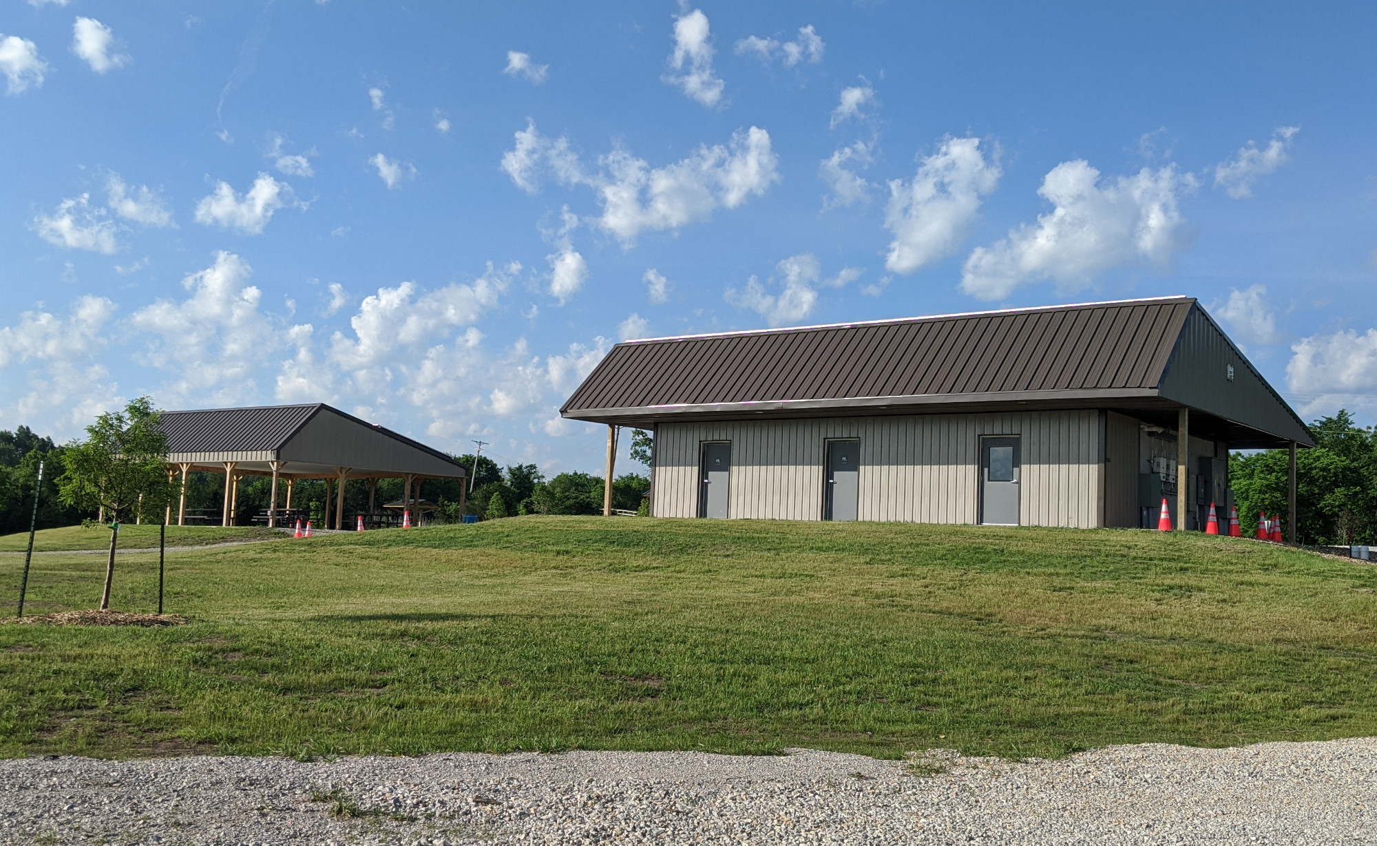 Shower house with individual, locking bathrooms. Shelter house in background.
