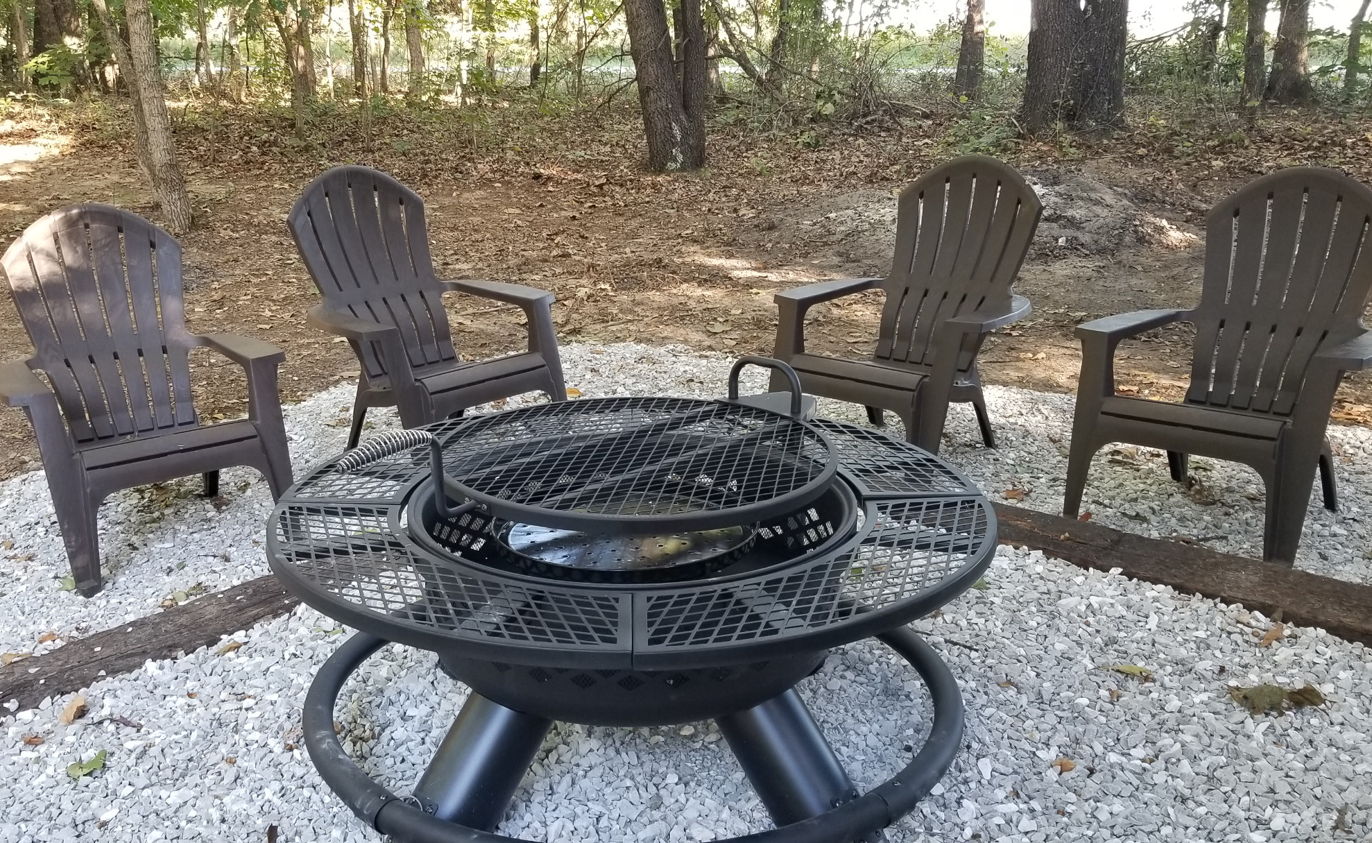 On a chilly night, cozy up to one of two firepit/grills on site. Also on site: a carport, ample boat and trailer parking, a storm shelter, and RV site that can be booked separately..
