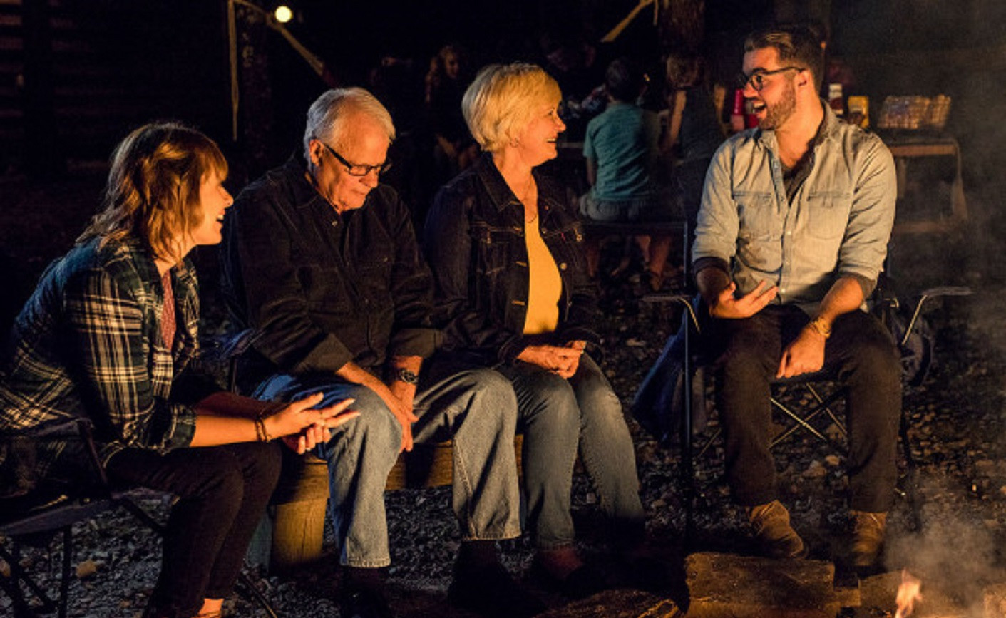 A Family enjoys an evening around the campfire.