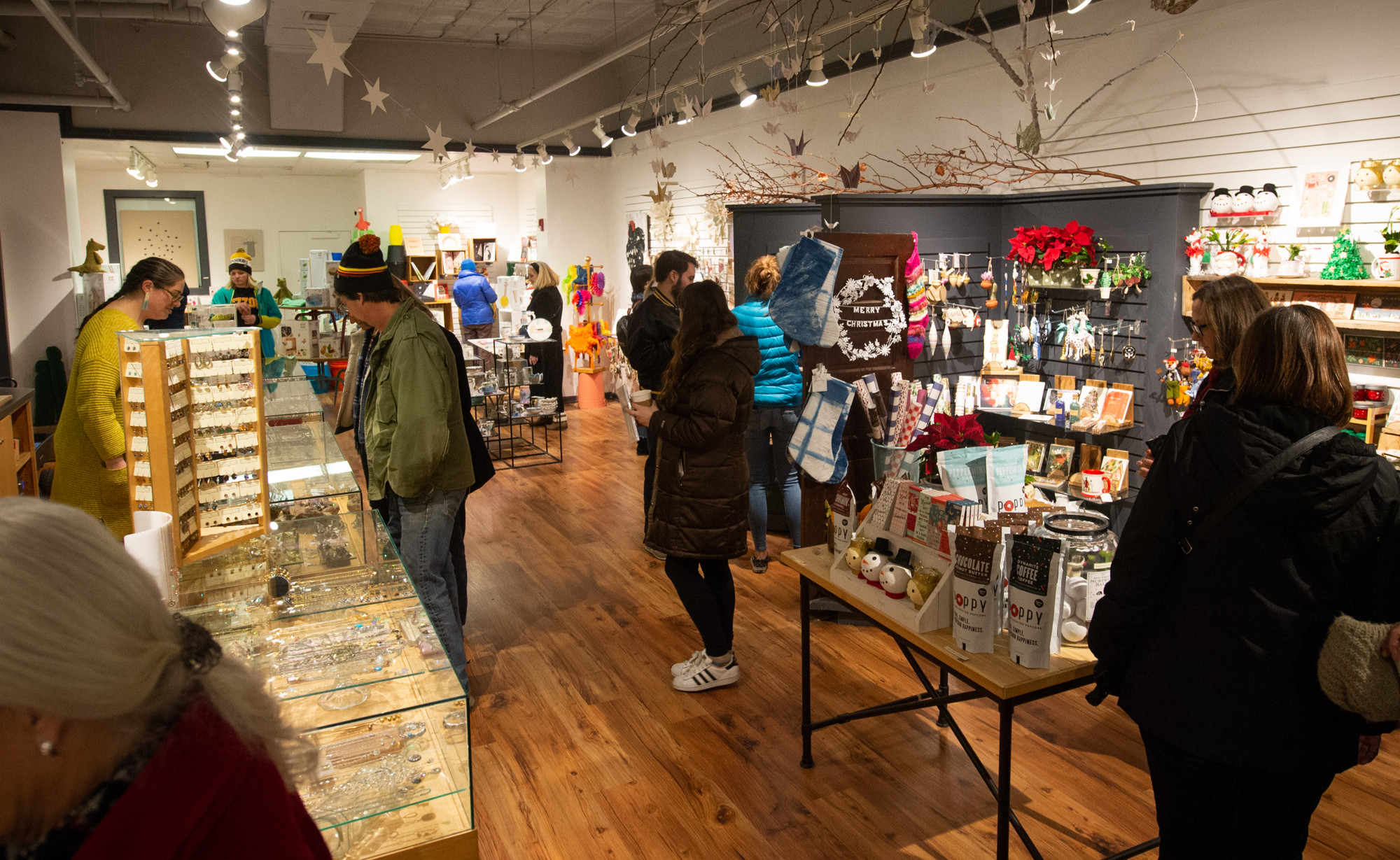 People shop for the holidays inside Poppy. The District hosts multiple shop hops throughout the year. These include the Holiday Shop Hop, Spring Shop Hop, and the Dog Days Sale.