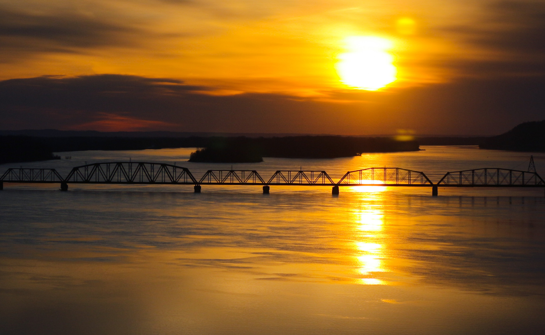 Sunrise on the Mighty Mississippi. Kansas City Southern Railroad bridge circa 1873.