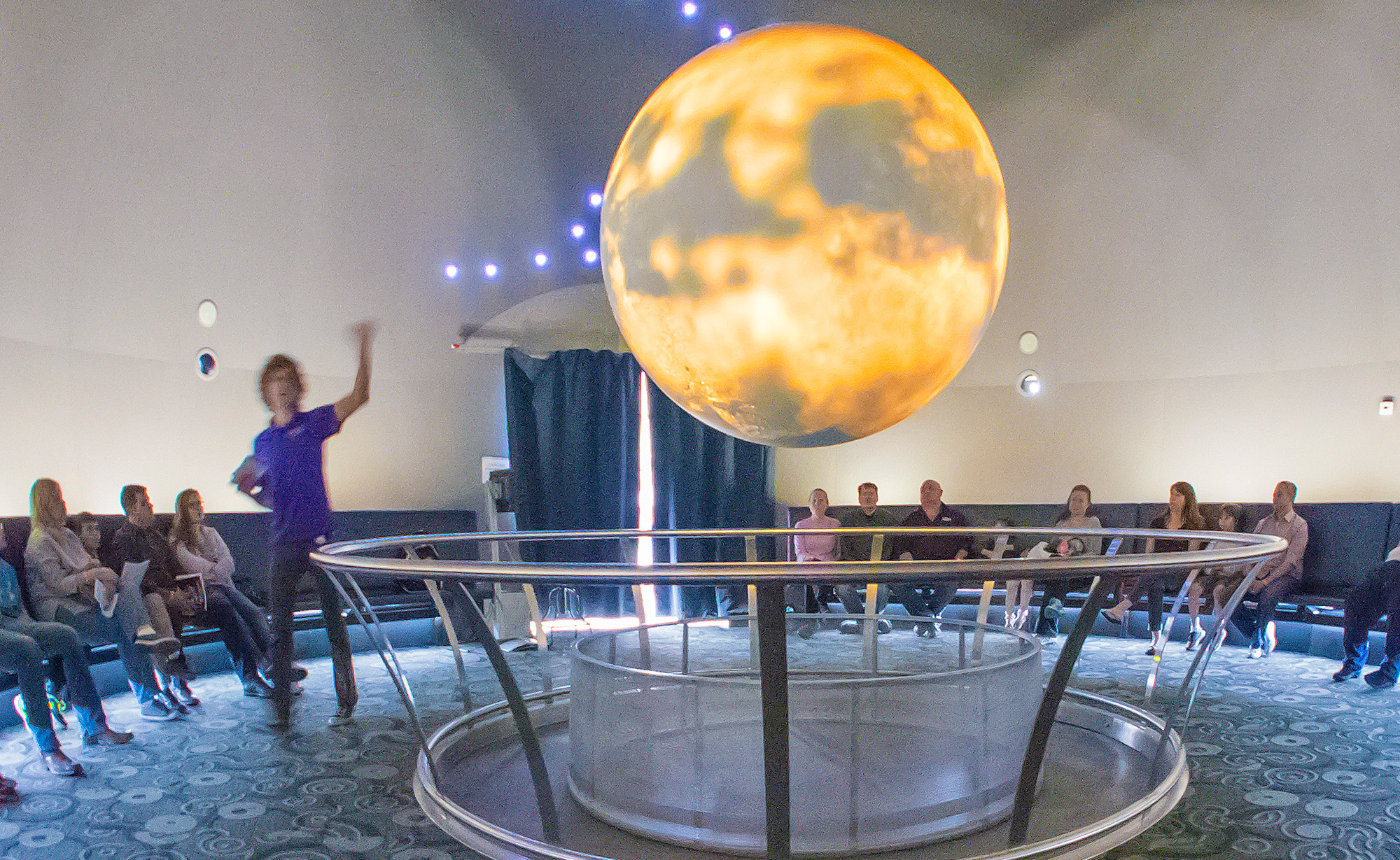Chris Steinauer of the Science City education staff, described Titan, one of Jupiter’s moons, to an audience assembled for National Astronomy Day at Union Station Kansa City 042515. The presentation, Mgaa Moons, took place in the station’s
