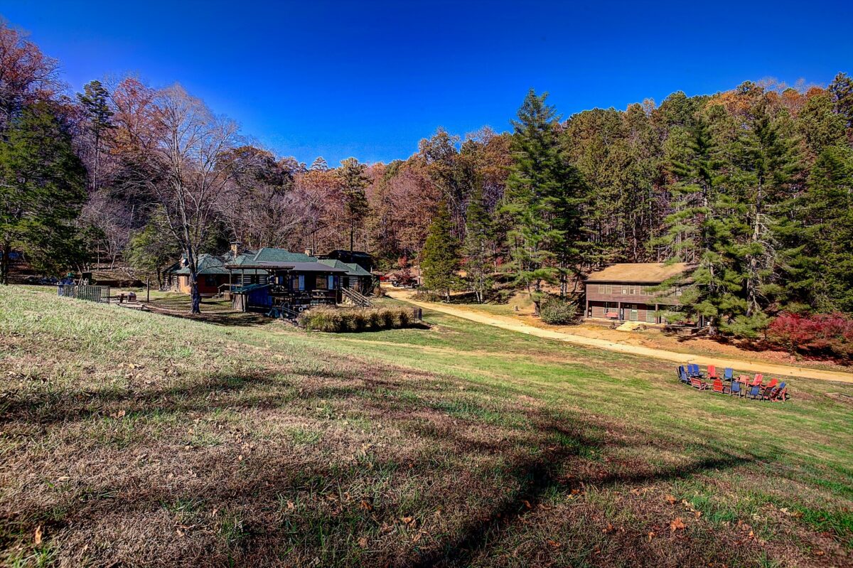 A cabin a patch of grassy wilderness.