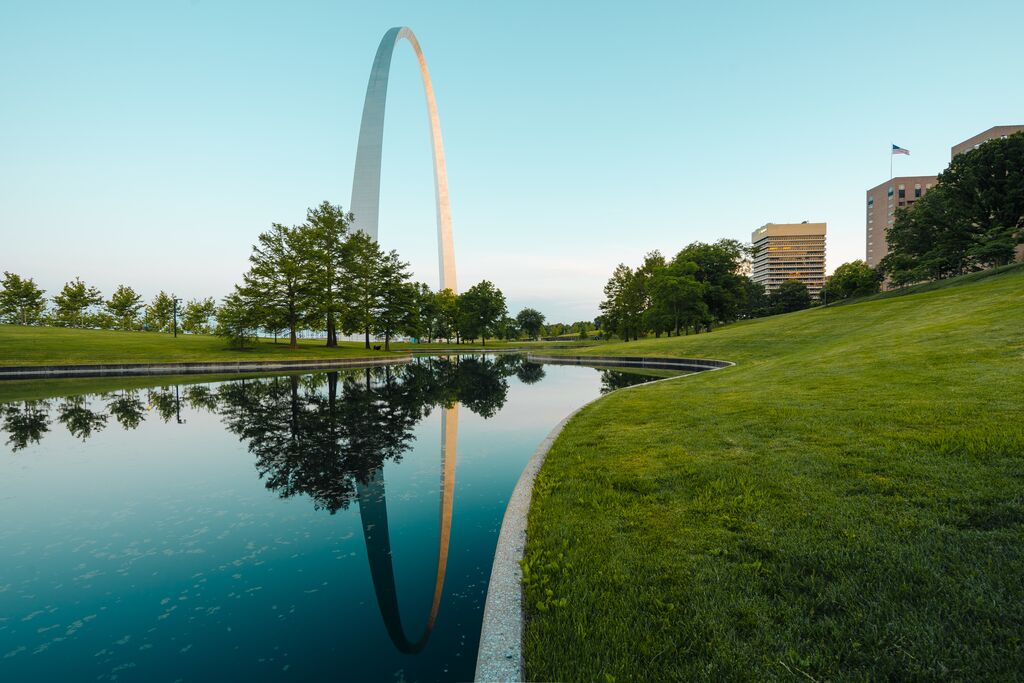 The Gateway Arch sits behind a reflecting pool at Gateway Arch National Park in St. Louis.