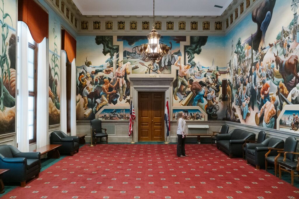 A woman views the Thomas Hart Benton mural "Social History of Missouri inside the Missouri State Capitol in Jefferson City.