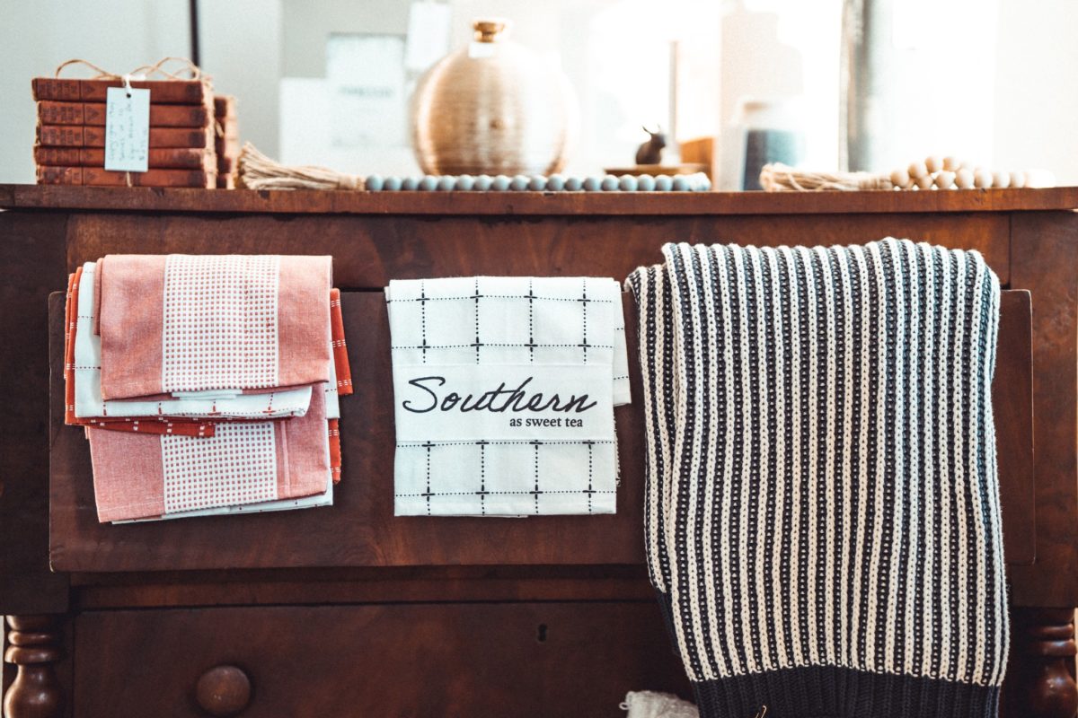 A dresser with assorted wash cloths and other items arranged.