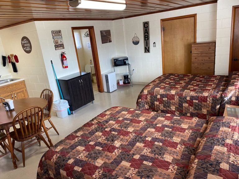 A furnished room in a cabin with two beds.