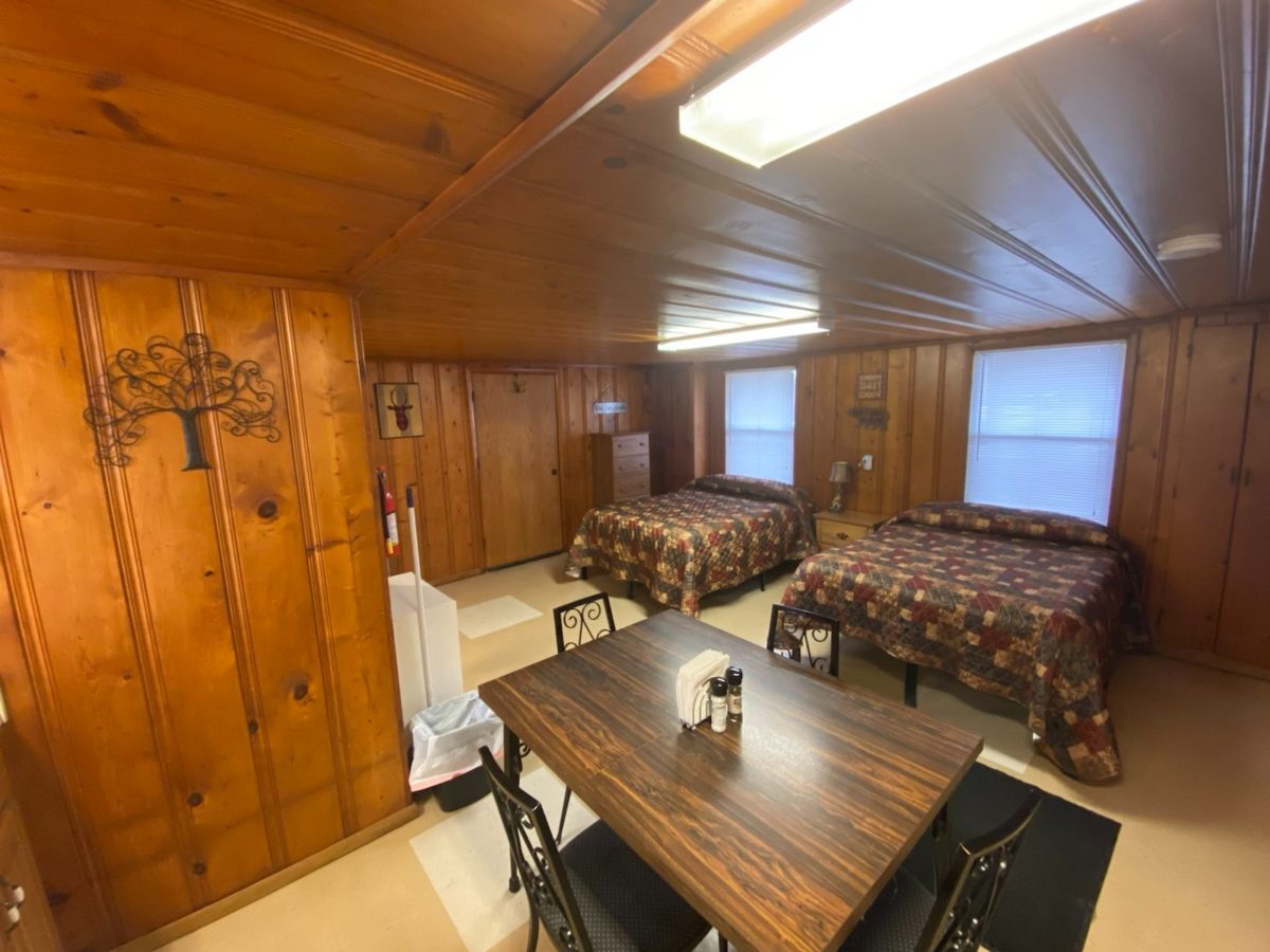 A furnished room in a cabin with two beds.