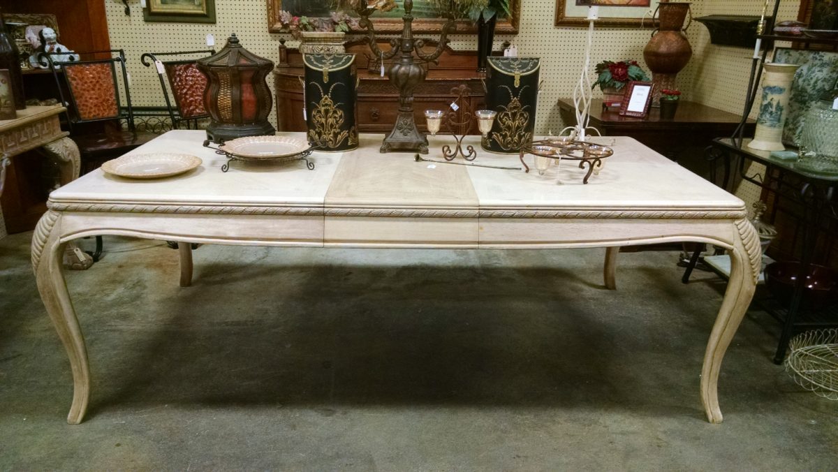 A table stacked with antiques.