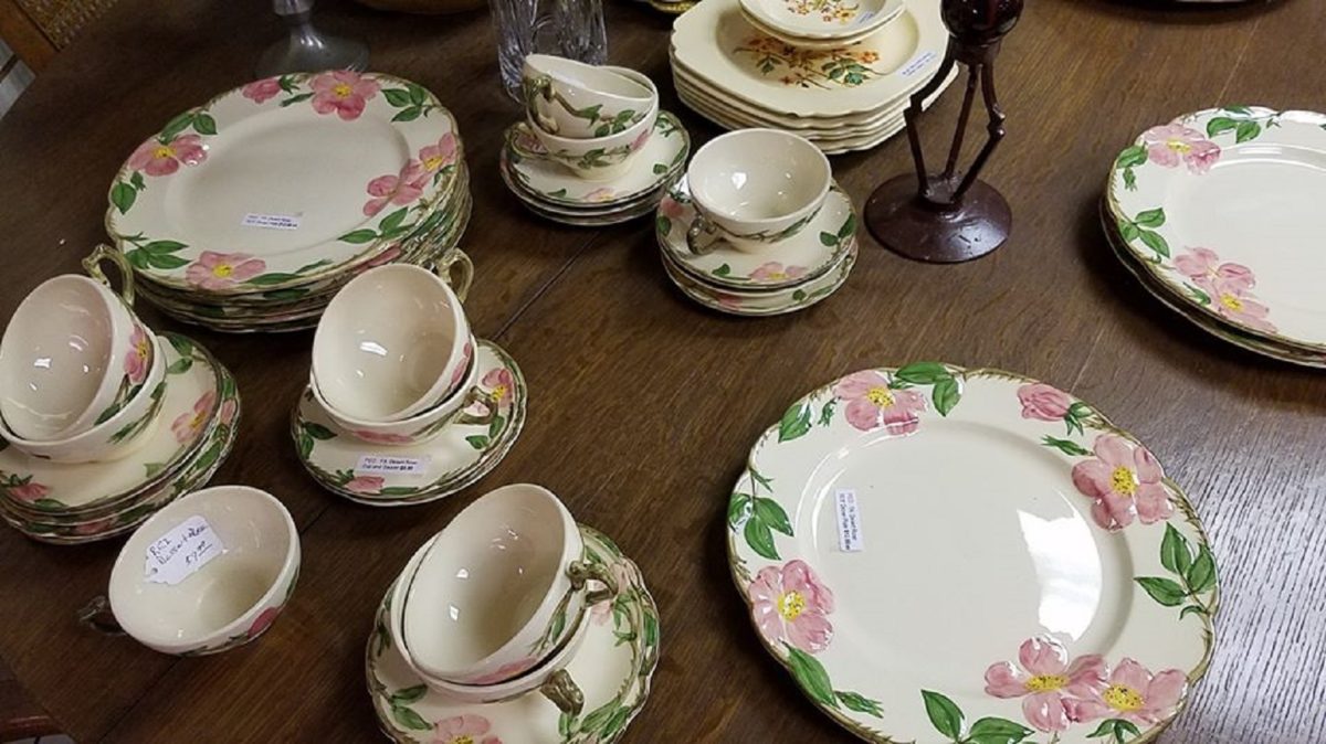 Plates and cups stacked on a table.