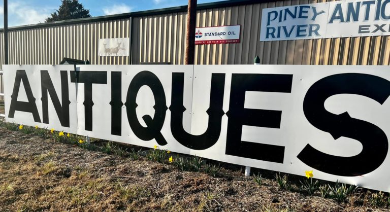 Exterior Sign of Antique Store- reads ANTIQUES