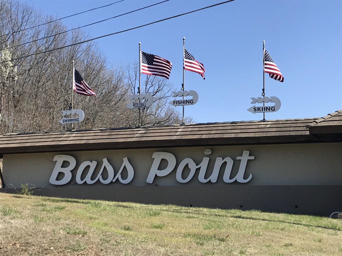 Flags fly over a wall that reads "Bass Point."