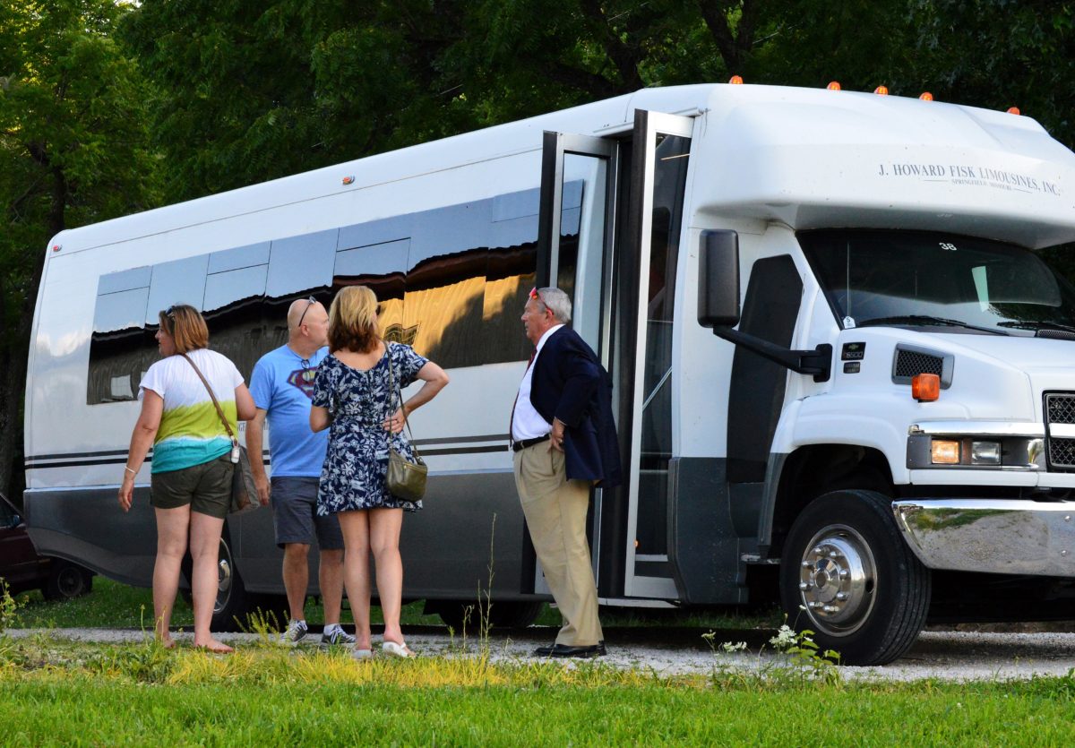 A group near a tour bus.