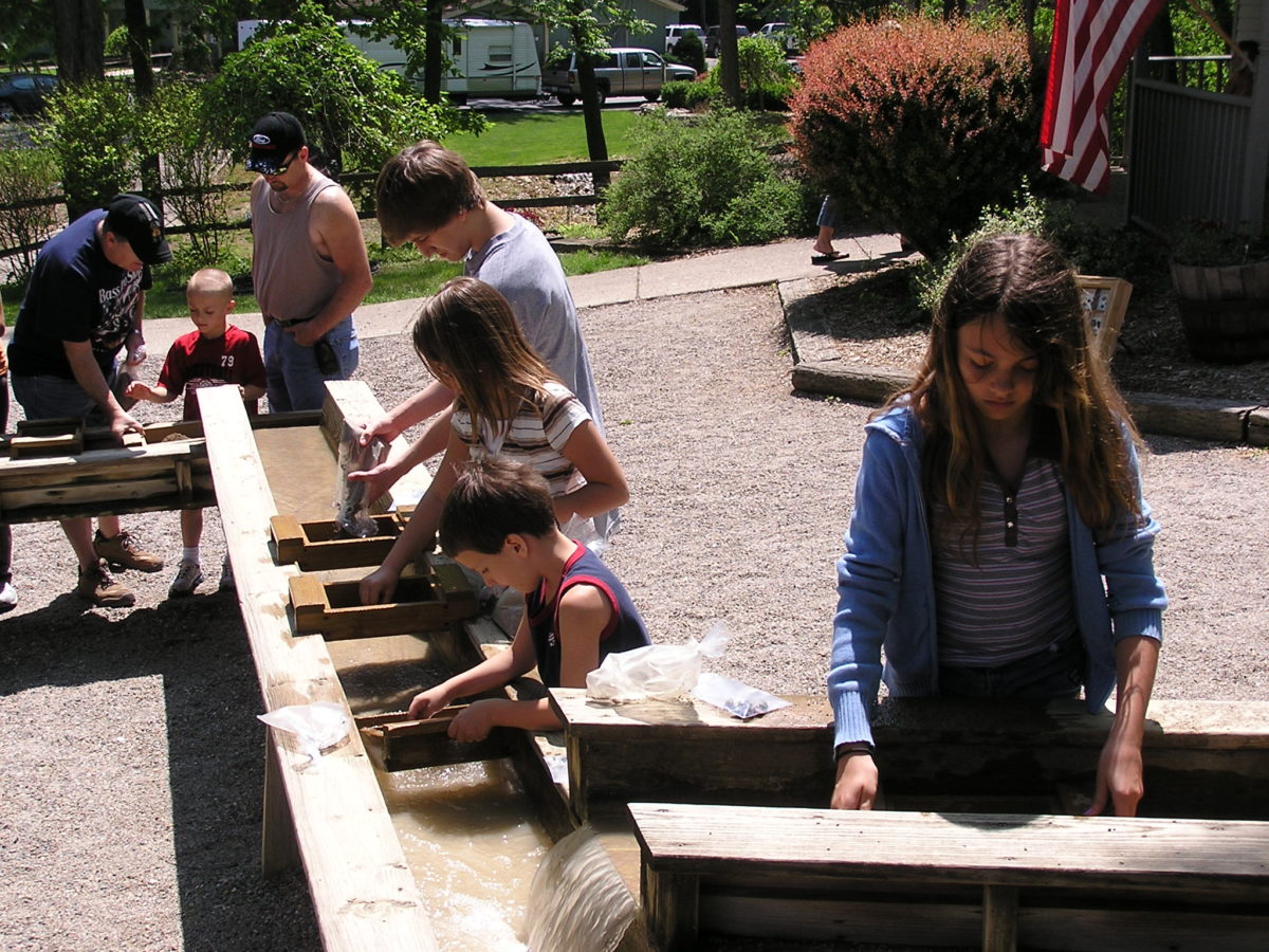 Children interact with an exhibit at a cave.