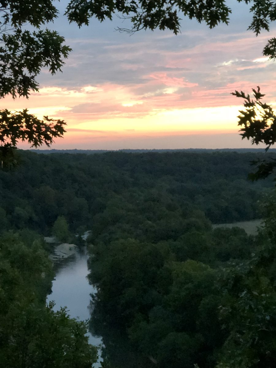 A river overlook beneath a sunset.