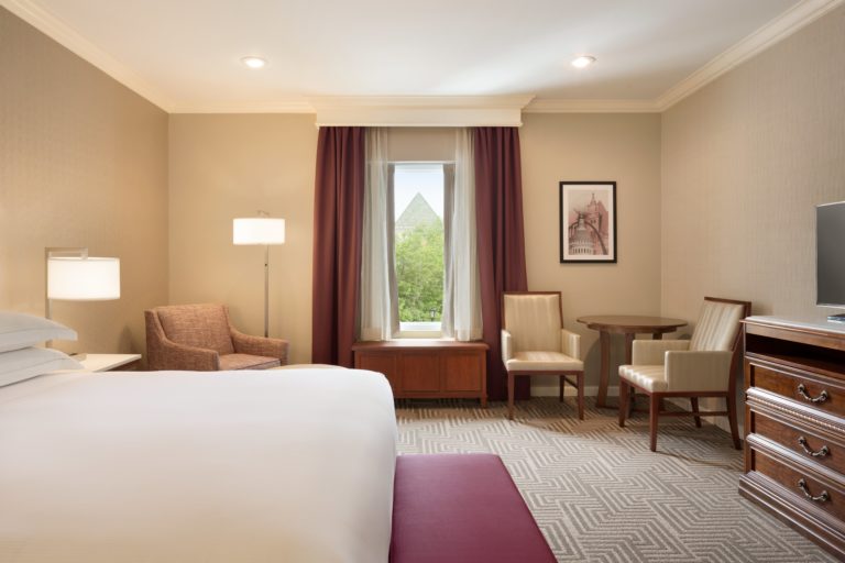 The interior of a furnished and well-lit hotel room.