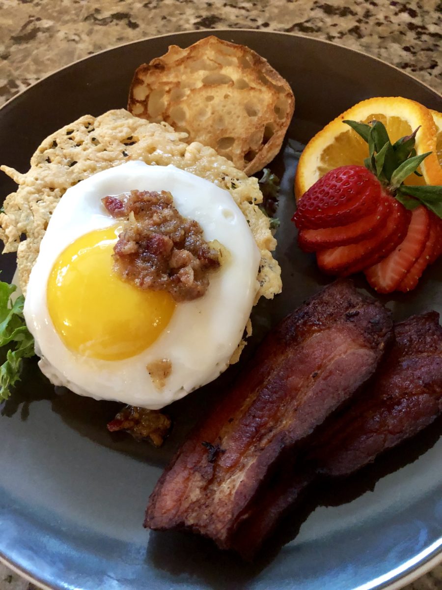 Breakfast foods, including eggs, bacon and fruit.