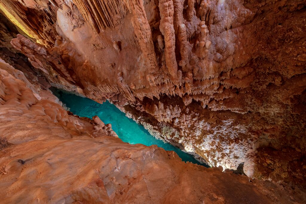 Blue water at the bottom of a cave