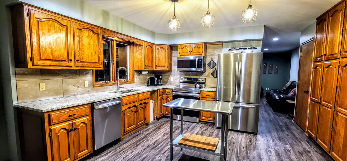 A modernized kitchen with wood accents.