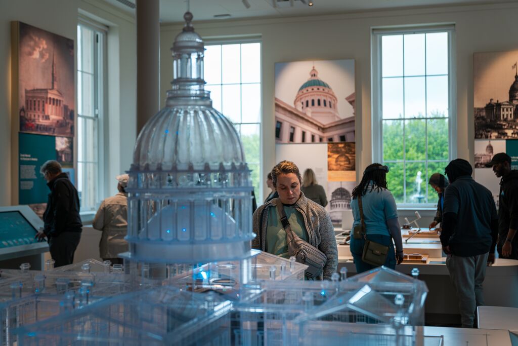 A person reads an interpretive panel in a museum.