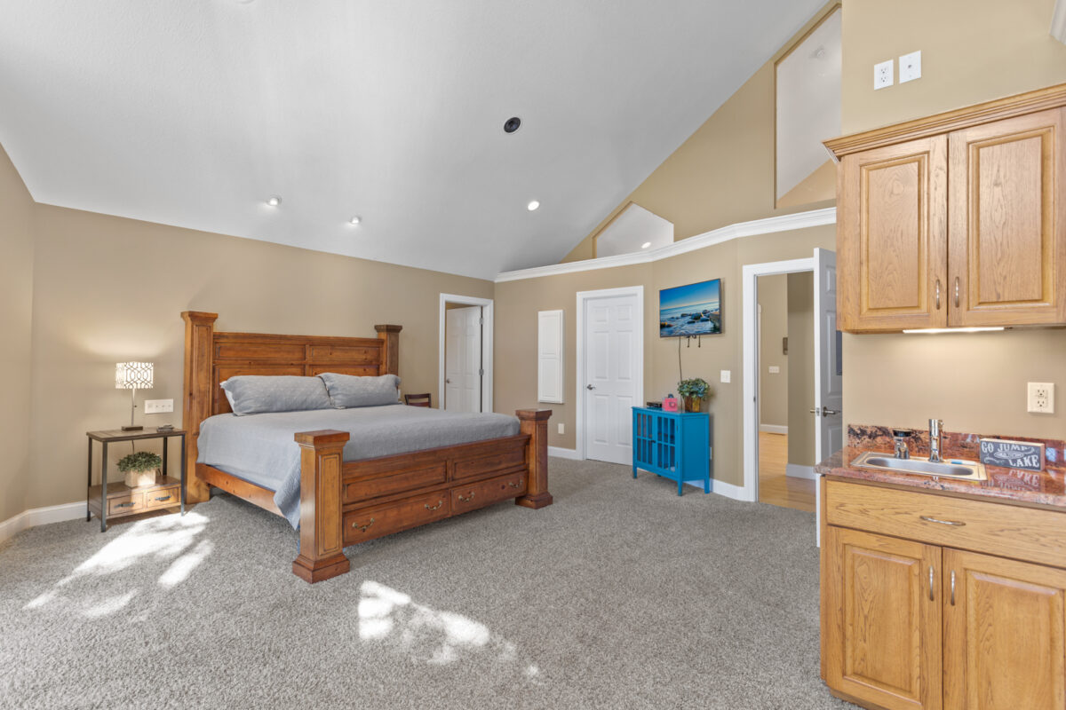 A furnished bedroom in a large vacation home.