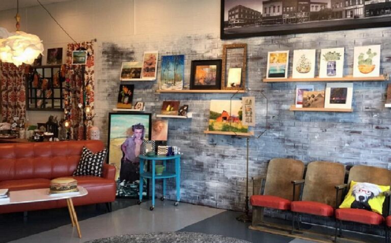 A gallery space in a frame shop, with seating and art along the walls.