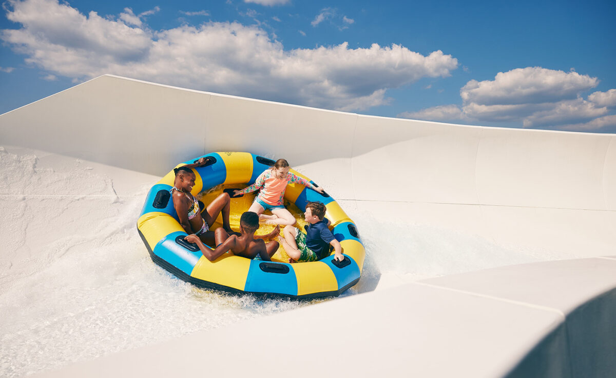 Diverse family rides a water slide at White Water in Branson Missouri