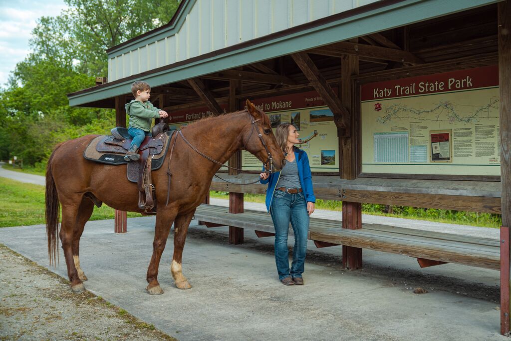 Woman and boy on horseback at Katy Trail State Park.
 