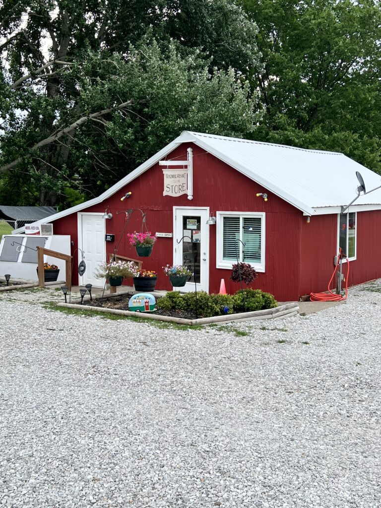 A red building amidst a gravel lot.