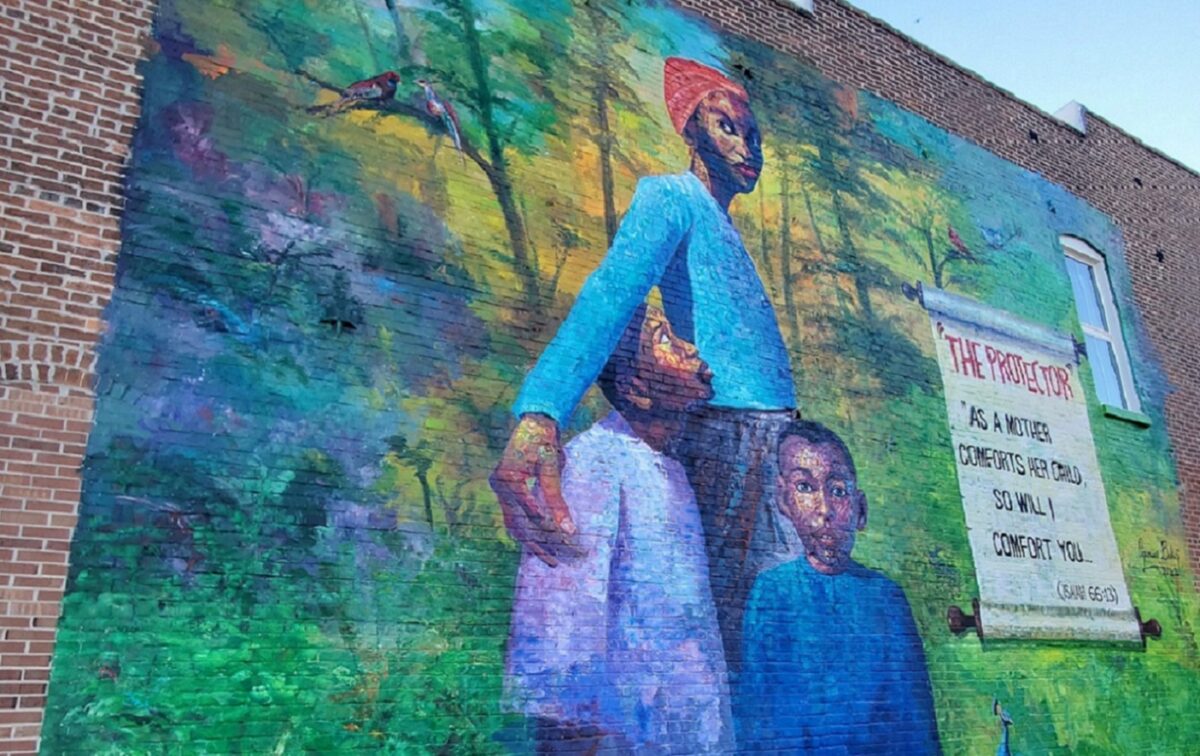 A colorful mural depicting a woman and two children.