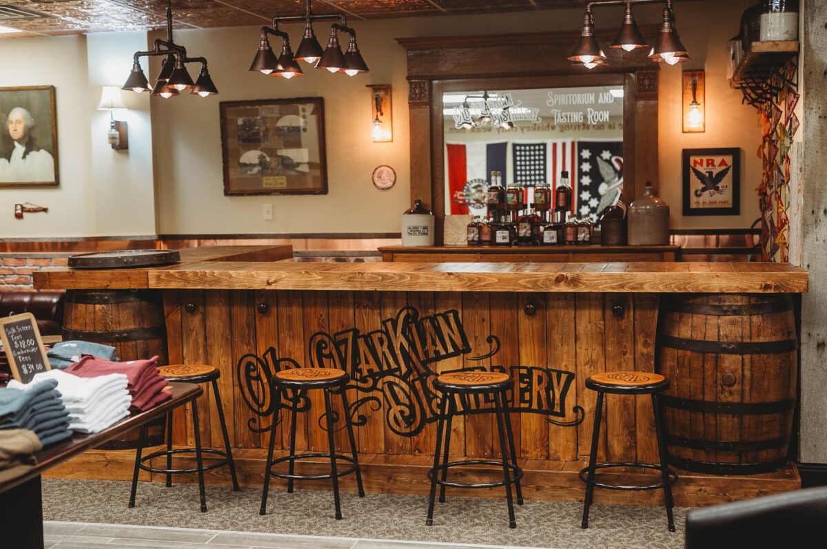 The interior of a tasting room, with a bar and stools.