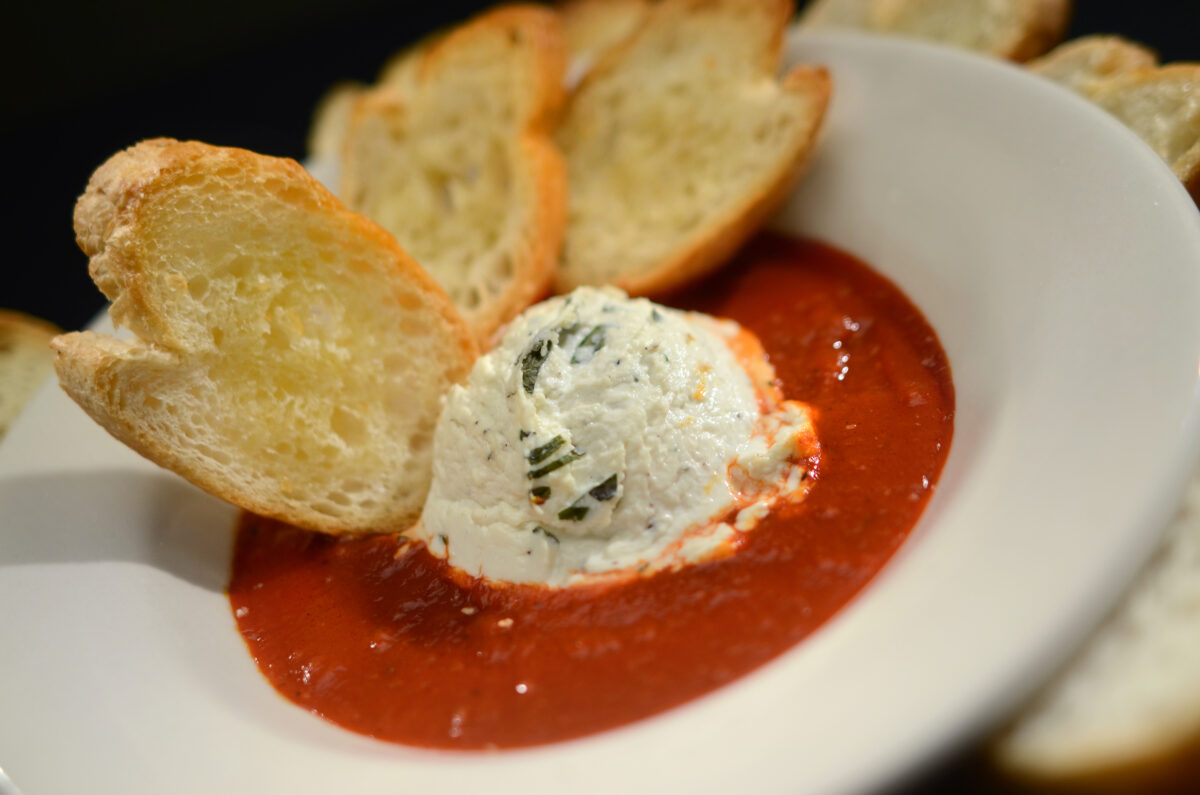 Baked chevre, plated on a table.