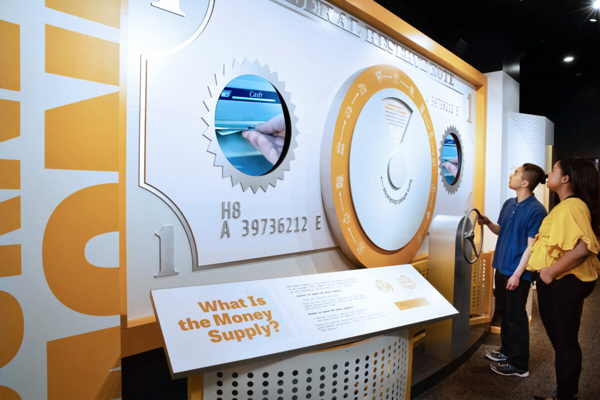Visitors interact with exhibits and displays in a museum.