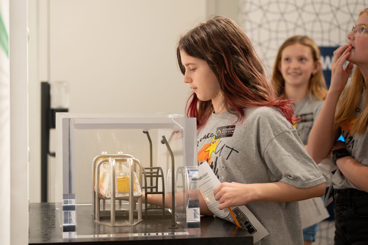 Visitors interact with exhibits and displays in a museum.