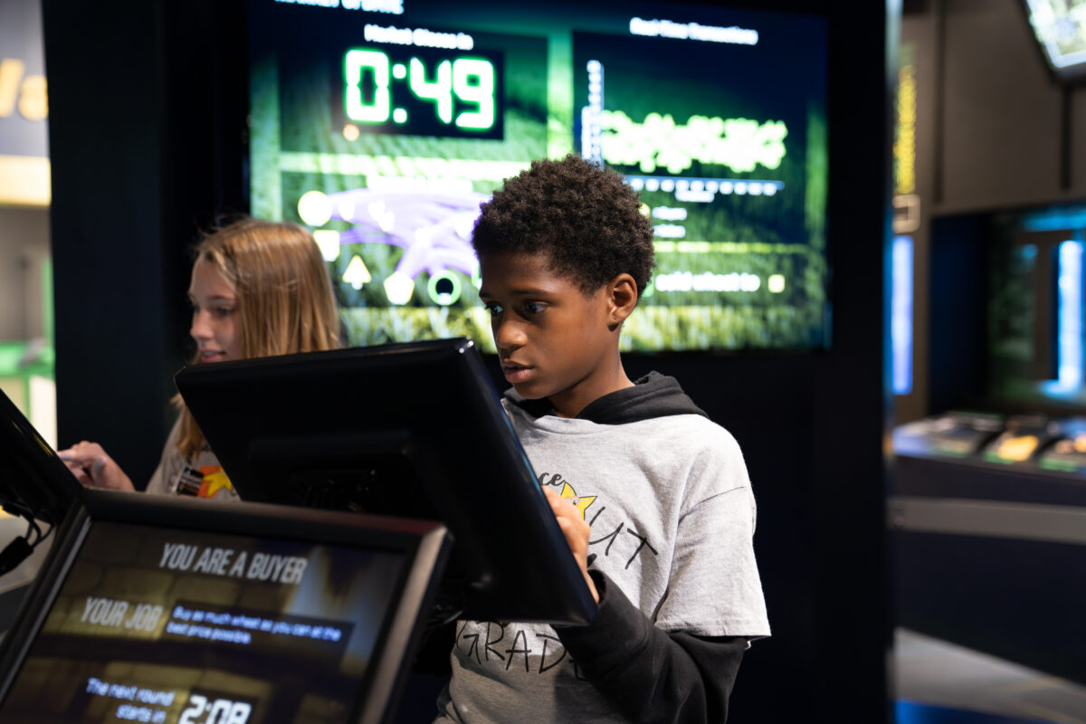 Students interact with exhibits and displays in a museum.