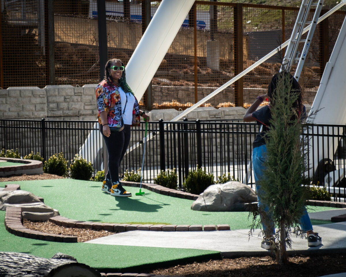 Two people out on a mini golf course.