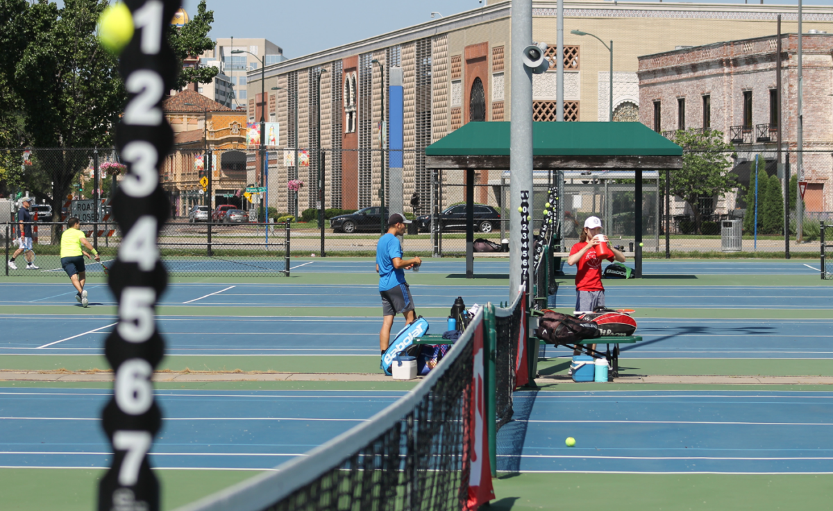 A photo of two players taking a break on the Plaza Tennis Center courts.