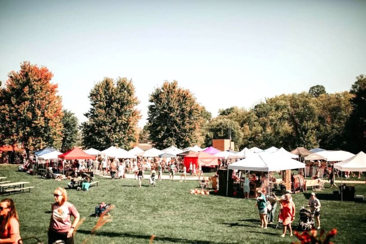 Attendees of a fall festival outside in nature.
