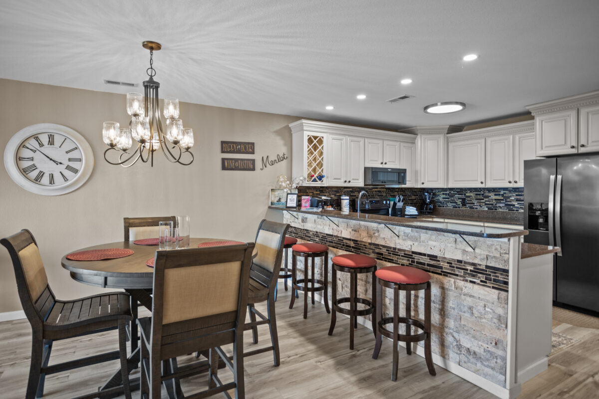 The dining room and kitchen of a modern condo.