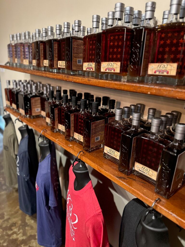 Bottles and merchandise lined up on shelves.