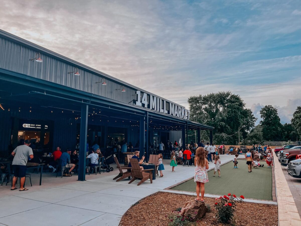 People gather outside of a large food hall.