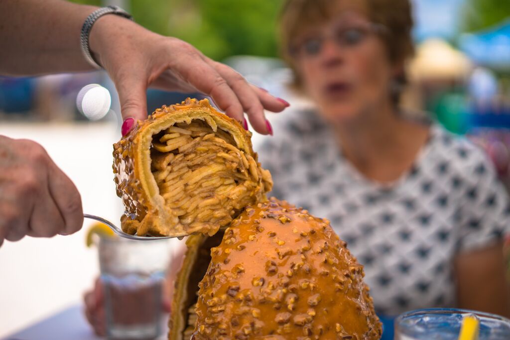A person marvels at a slice of Levee High Apple Pie.