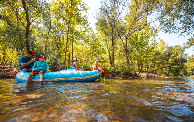 People on boats in the river.
