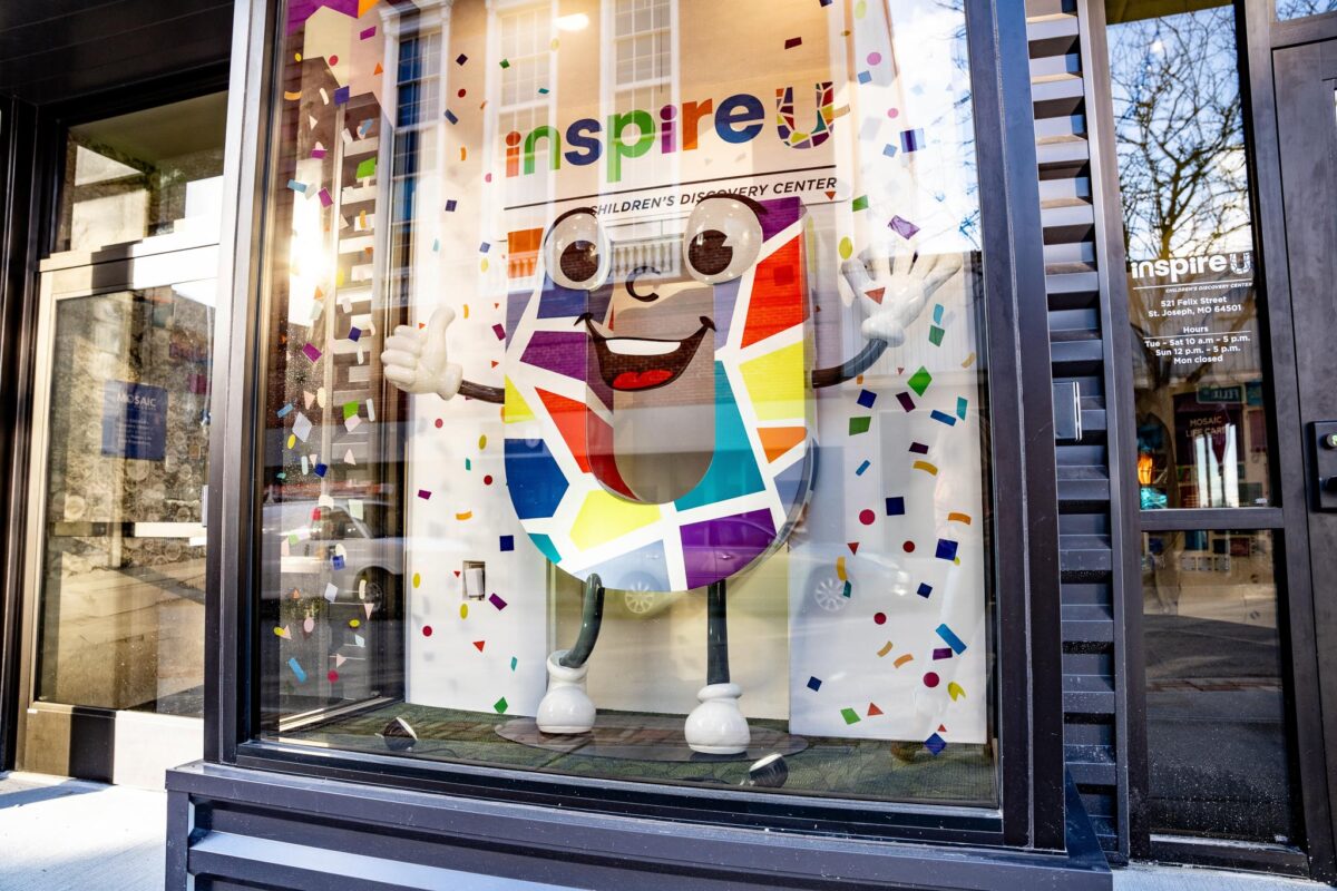 A cartoony figure smiles in a display.
