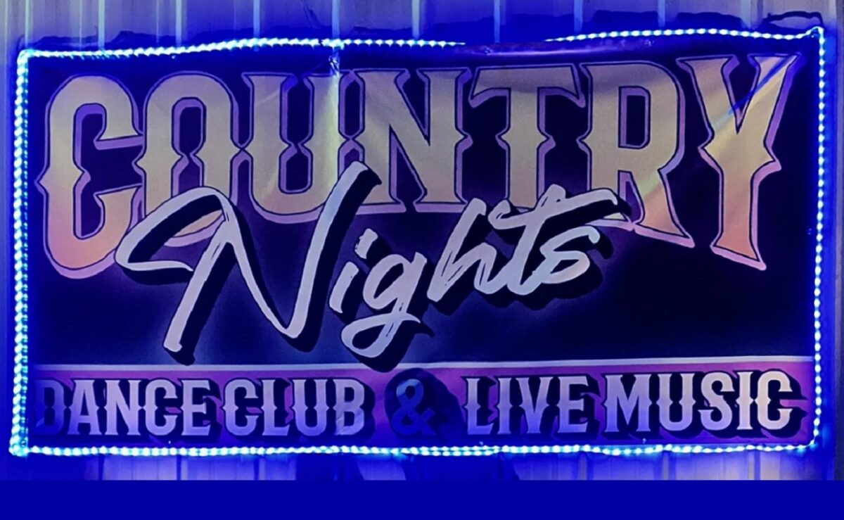 Lighted banner advertising Country Nights, a dance club with live music.
